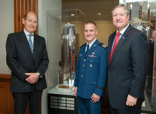 Secretary of the Air Force Michael Donley (right), Air Force Academy Cadet 1st Class Dustin Hayhurst (center) and David Cyster stand beside the Millennium Sword of Friendship May 10, 2012, in the Pentagon, Washington, D.C. Donley then presented the 2011 U.S. Air Force Cadet of the Year Award to Hayhurst, and Cyster presented Hayhurst a coin symbolizing presentation of the Sword to him in honor of being named the Cadet of the Year. Hayhurst earned the award by demonstrating excellence in military skills, academics and athletics in an Air Force commissioning program. Cyster is a member of the of the Air Squadron of the United Kingdom. (U.S. Air Force photo/Jim Varhegyi)