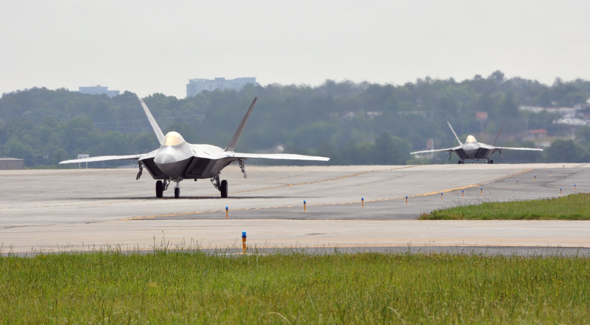 Raptors numbered 193 and 195 taxi down the runway at Dobbins Air Reserve Base on May 5.  The pilot of Raptor 193 is Col. Dirk Smith, 3rd Wing commander, and the pilot of Raptor 195 is Lt. Col. Paul Moga, 525th Fighter Squadron commander. The two jets were flown to Joint Base Elmendorf-Richardson. (U.S. Air Force photo/Airman 1st Class Elizabeth Gaston)