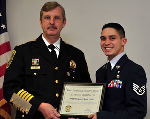 Staff Sgt. Luis Ortiz, 633rd Inpatient Operations Squadron NCO in charge of the birthing center, receives a Lifesaving Certificate from Sheriff J.D. Diggs, York-Poquoson Sheriff, during a ceremony at the York-Poquoson Sheriff's Office, Yorktown, Va., May 11, 2012. Ortiz earned the certificate by saving the life of Newport News, Va. native, Gustavo Diaz. (U.S. Air Force photo by Senior Airman Jarad A. Denton/Released)