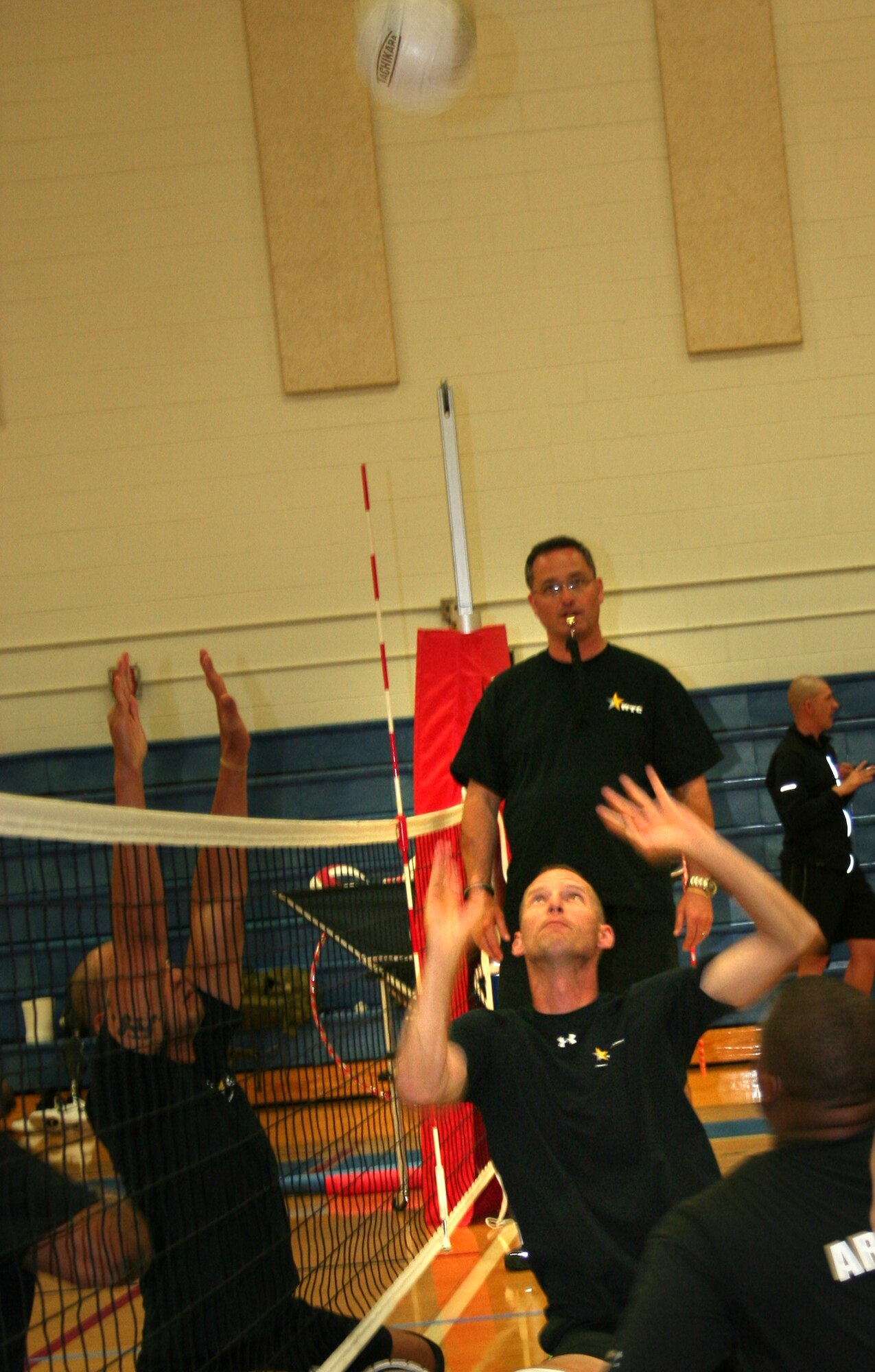 U.S. Army Cpl. Brian Miller, center, currently assigned to the Warrior Transition Unit, Fort Eustis, Va., launches the volleyball across the net during a game of sitting volleyball. Miller, who lost his leg due to an improvised explosive device in Iraq, participated in the 2012 Warrior Games in Colorado Springs, Colo. April 30 – May 5. (Courtesy photo)