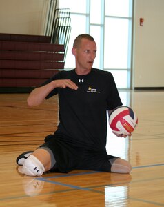 U.S. Army Cpl. Brian Miller, currently assigned to the Warrior Transition Unit, Fort Eustis, Va., prepares to serve during a game of sitting volleyball. Miller participated in the 2012 Warrior Games in Colorado Springs, Colo. April 30 – May 5. (Courtesy photo)