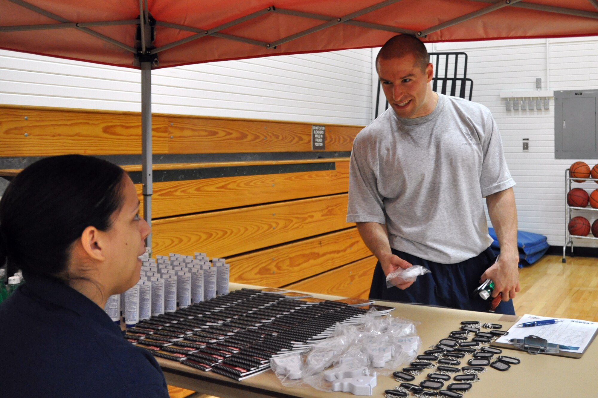 YOUNGSTOWN AIR RESERVE STATION, Ohio – U.S. Air Force Staff Sgt. Anthony Niederriter, 910th Logistics Readiness Squadron vehicle operator, discusses the activities available to him with Senior Airman Glysette Delvalle, 910th Force Support Squadron services specialist, during the fifth annual YARS Fitness Fair May 5, 2012, here. U.S. Air Force photo by Staff Sgt. Megan Tomkins