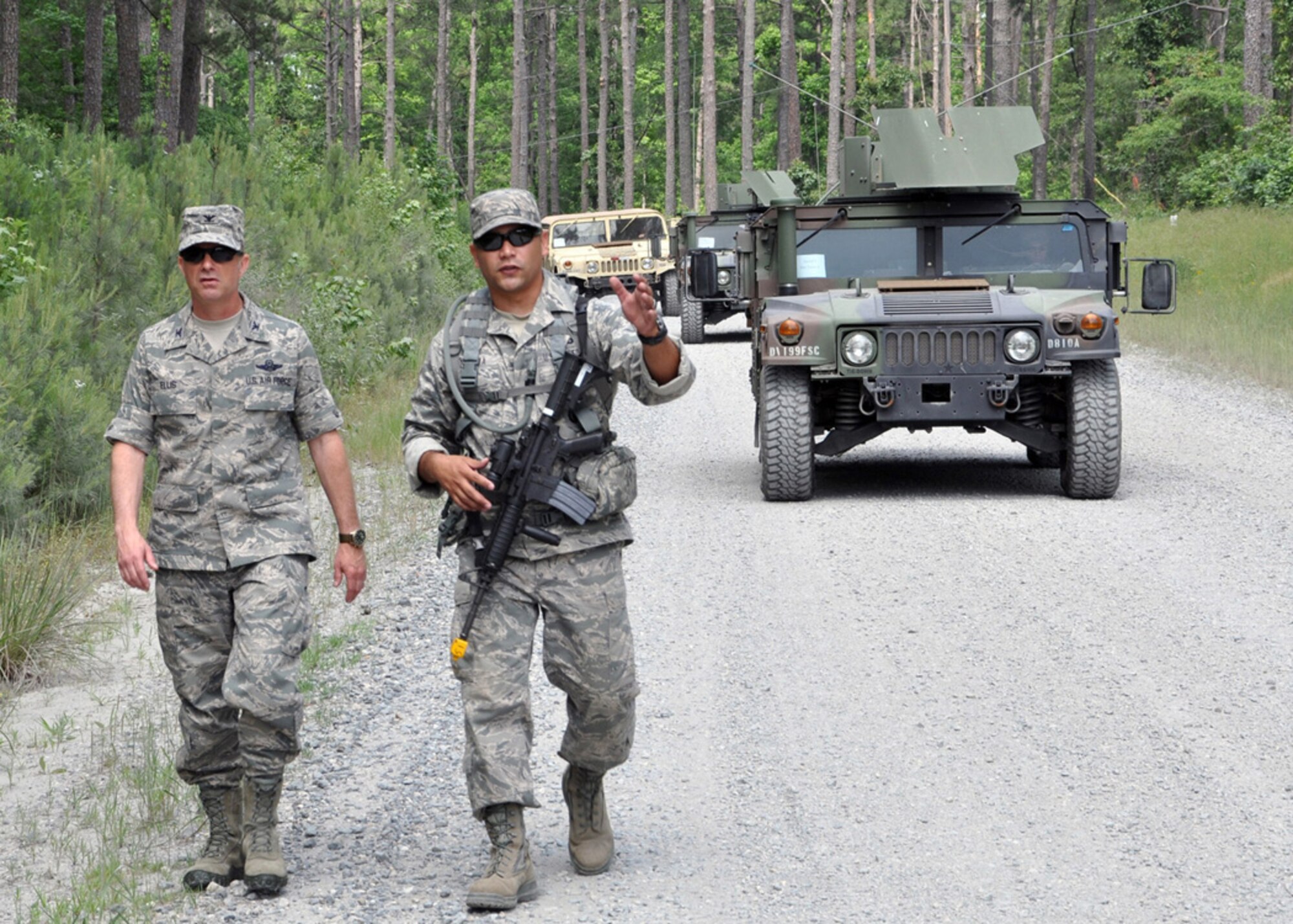 Col. Jon Ellis, 307th Bomb Wing commander shadows Tech. Sgt. Daniel Zamora, 307th Security Forces Squadron, as he searches for improvised explosive devices (IEDs) during a two-day Bivouac at the Warfare Training Center on Barksdale Air Force Base, La., May 5-6, 2012.  Approximately 50 members of the 307th SFS participated in the IED detection, land navigation and hostile vehicle stops and searches training.  (U.S. photo/Master Sgt. Mary Hinson)