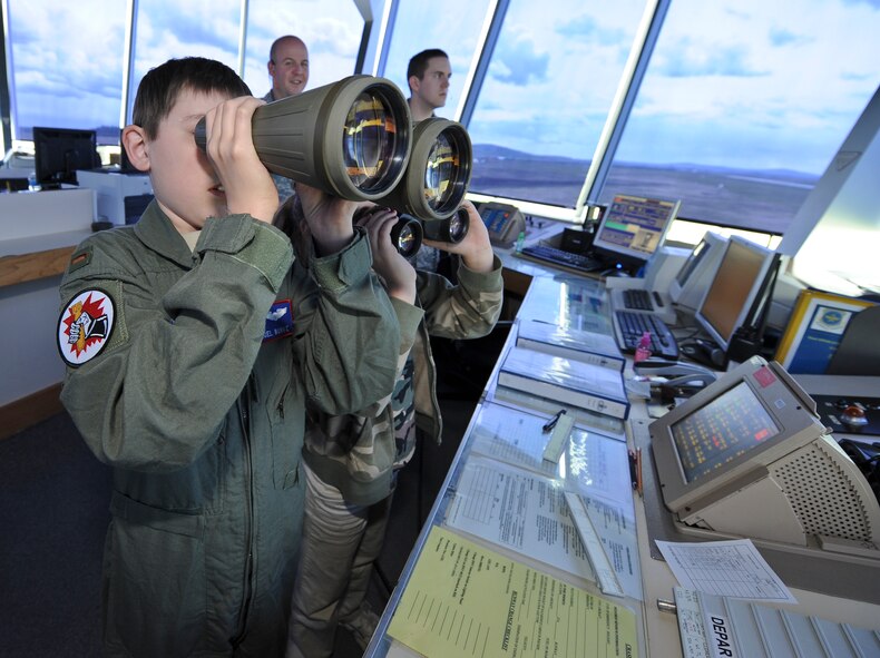 Samuel Burke, a 10-year-old Spokane, Wash., boy fighting a cancerous tumor on his optic nerve, and his sister, Madeline, peer through binoculars in the 92nd Operations Support Squadron’s air traffic control tower during their tour of various agencies across the installation at Fairchild Air Force Base, Wash., May 4, 2012. Sam was the first community member to participate in the newly constructed program deemed, “Airman for a Day”. (U.S. Air Force photo by Senior Airman Benjamin Stratton/Released)