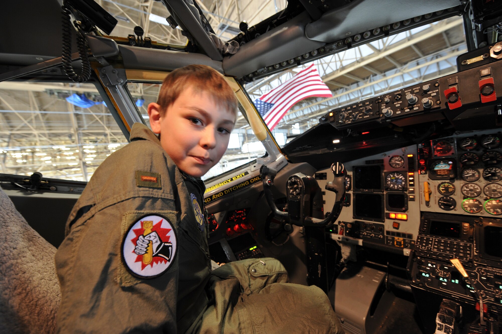 Samuel Burke, a 10-year-old Spokane, Wash., boy fighting a cancerous tumor on his optic nerve, checks out the cockpit of a KC-135 Stratotanker in the maintenance hangar during his tour of various agencies across the installation at Fairchild Air Force Base, Wash., May 4, 2012. Sam is an avid watcher of the Military Channel on television and said he one day would like to join the service. (U.S. Air Force photo by Senior Airman Benjamin Stratton/Released)