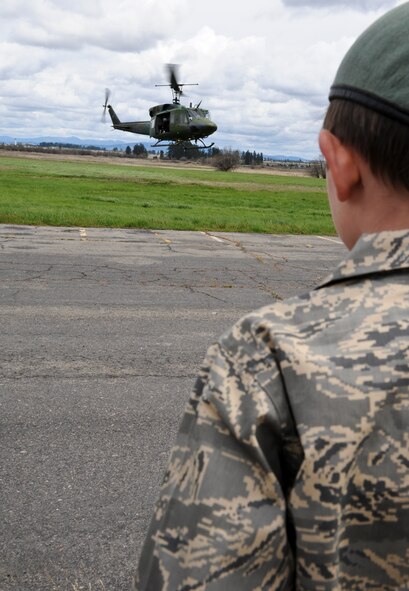 Samuel Burke, a 10-year-old Spokane, Wash., boy fighting a cancerous tumor on his optic nerve, watches as a 36th Rescue Flight UH-1N Iroquois lands falling a training mission during Burke’s tour of various agencies across the installation at Fairchild Air Force Base, Wash., May 4, 2012. Sam was the first community member to participate in the newly constructed program deemed, “Airman for a Day”. (U.S. Air Force photo by Senior Airman Benjamin Stratton/Released)