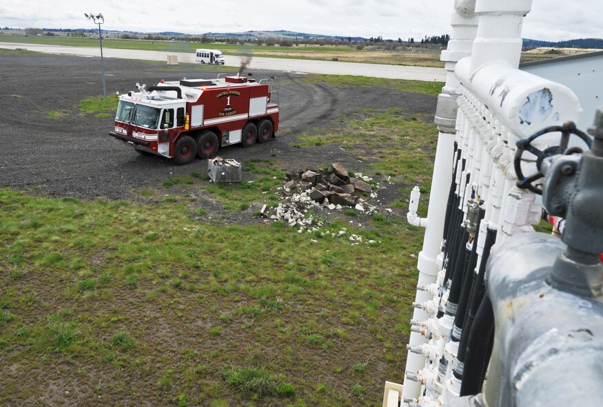 A 92nd Civil Engineer Squadron fire truck, Crash 1, responds during a training exercise with Samuel Burke, a 10-year-old Spokane, Wash., boy fighting a cancerous tumor on his optic nerve, on board as part of his tour of various agencies across the installation at Fairchild Air Force Base, Wash., May 4, 2012. Sam has undergone 1.5 years of chemo therapy. (U.S. Air Force photo by Senior Airman Benjamin Stratton/Released)