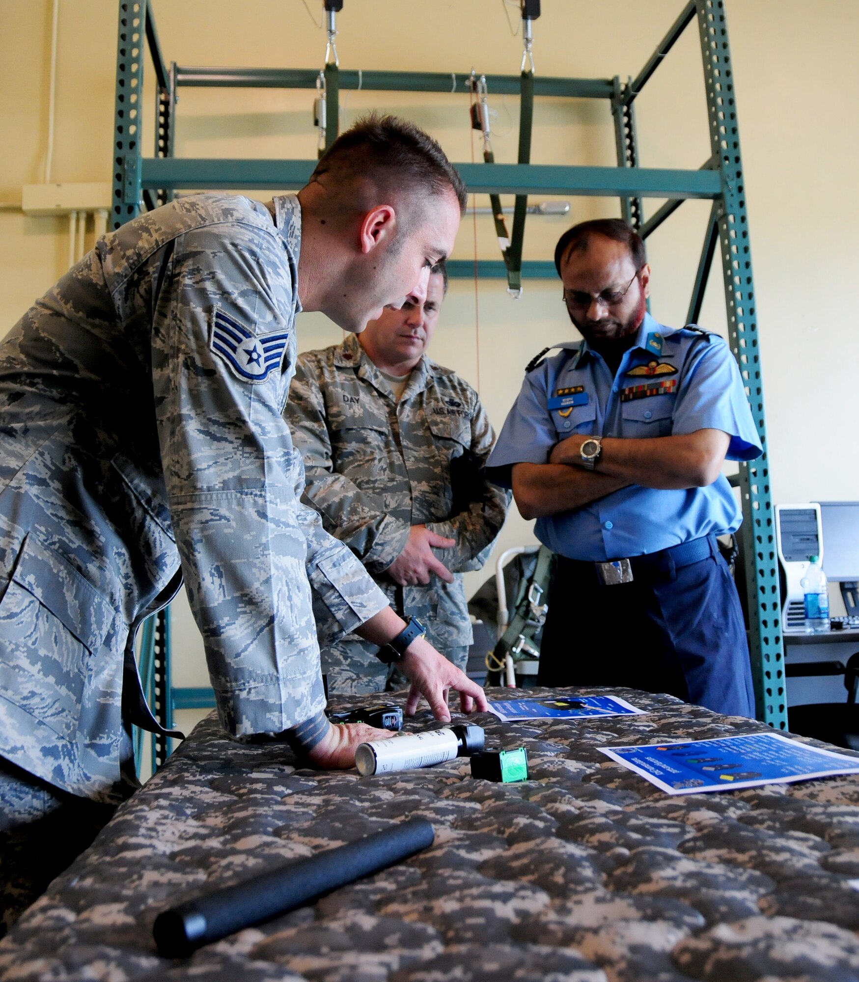 Staff Sgt. Nicholas Shonk, 736th Security Forces Squadron, provides a non lethal weapons overview for host nation representatives during the Pacific Defender subject matter expert exchange May 10. The weapons overview was one of many facets covered during the five-day event.  The SMEE also showcases U.S. commitment to its allies and partners in the Asia-Pacific region. (U.S. Air Force photo by Senior Airman Jeffrey Schultze/released)