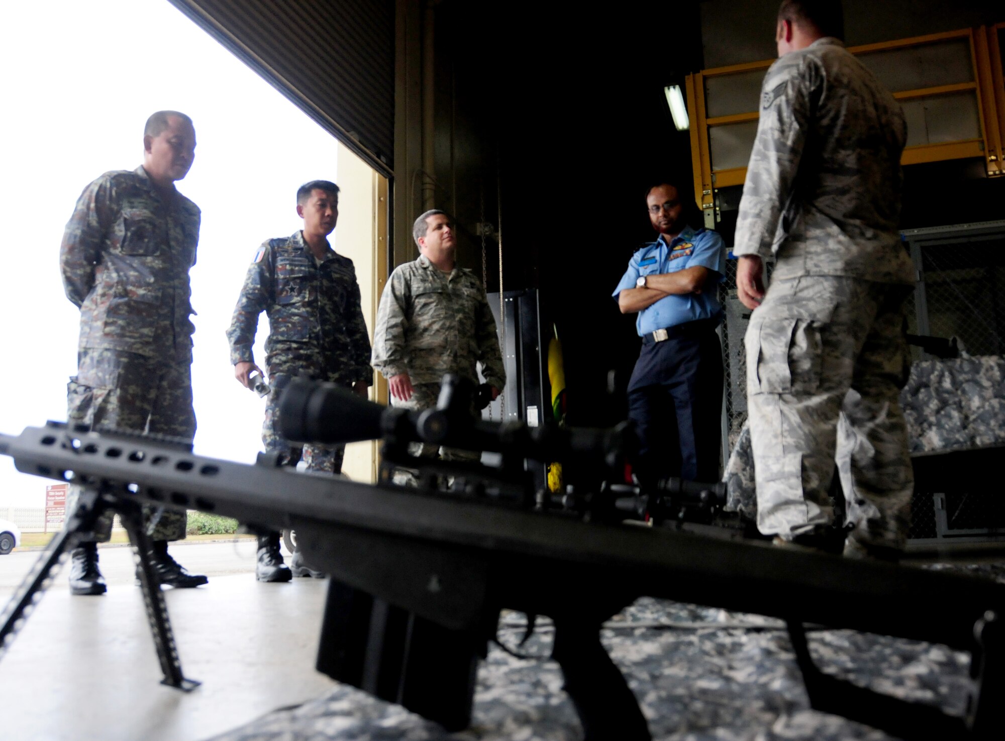 Staff Sgt. James Foster, 736th Security Forces Squadron, provides a weapons demonstration for host-nation representatives during the Pacific Defender subject matter expert exchange May 10. The SMEE allows partner nations to exchange ideas and methods of training within the Pacific region and showcases the U.S.s commitment to its allies and partners in the Asia-Pacific region (U.S. Air Force photo by Senior Airman Jeffrey Schultze/released)