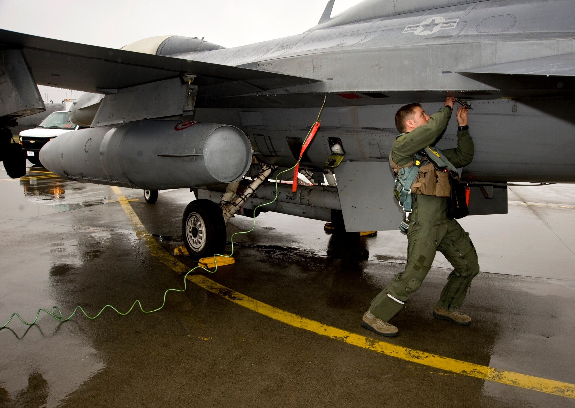 U.S. Air Force Capt. Jason Schaub, 14th Fighter Squadron pilot, performs a pre-flight inspection on an F-16 Fighting Falcon during the Diesel Weasel Exercise at Misawa Air Base, Japan, May 10, 2012. As part of the exercise, members of the 14 FS worked with joint terminal attack controllers to respond to realistic scenarios. (U.S. Air Force photo by Staff Sgt. Nathan Lipscomb/Released)