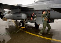 U.S. Air Force Capt. Jason Schaub, 14th Fighter Squadron pilot, performs a pre-flight inspection on an F-16 Fighting Falcon during the Diesel Weasel Exercise at Misawa Air Base, Japan, May 10, 2012. As part of the exercise, members of the 14 FS worked with joint terminal attack controllers to respond to realistic scenarios. (U.S. Air Force photo by Staff Sgt. Nathan Lipscomb/Released)