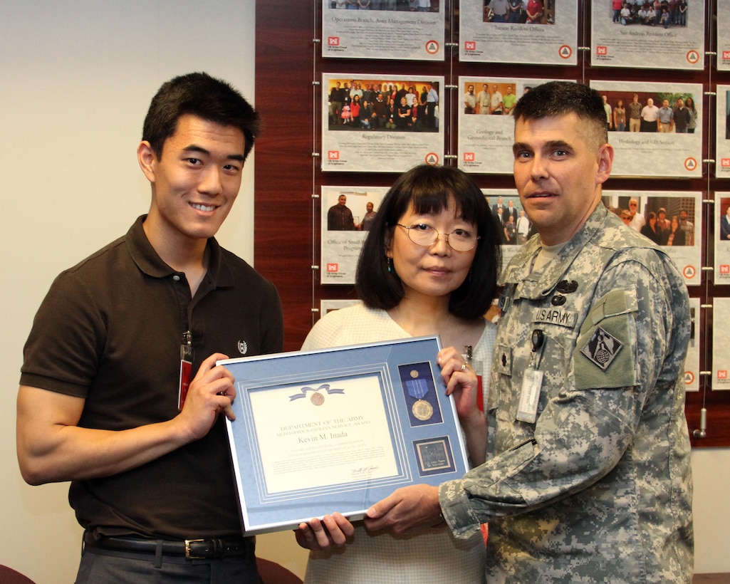 Lt. Col. Steven Sigloch (right) presents former Deputy Chief of Construction Division Kevin Inada's Meritorious Civilian Service Award to Inada's son Ben and wife Judy during a dedication ceremony at the District headquarters May 4.  Inada passed away suddenly Jan. 1 and the District's executive conference room and employee of the quarter award were named for him.  