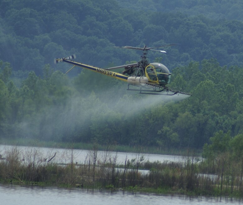 OKLAHOMA — A helicopter sprays an EPA-approved herbicide over an Interior Least Tern island along the McClellan-Kerr Arkansas River Navigation System; this is the first time a helicopter was used. In the past, the U.S. Army Corps of Engineers Tulsa District sprayed by boat, which was more time consuming, costly and less effective.