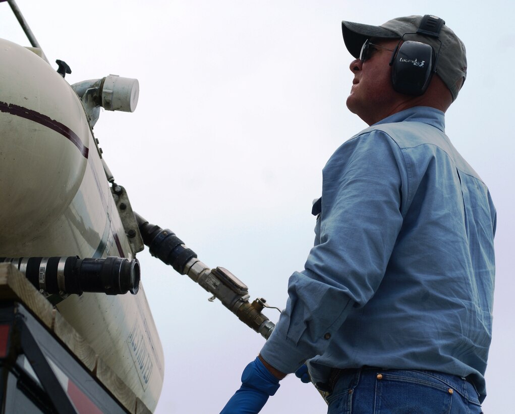 OKLAHOMA — Dick Fluke, contractor from AirPro, Inc. refuels the helicopter used to spray an EPA-approved herbicide on Interior Least Tern islands on the McClellan-Kerr Arkansas River Navigation System in Oklahoma. This is the first time the Corps has sprayed by helicopter. In the past, the herbicide was administered by boat.