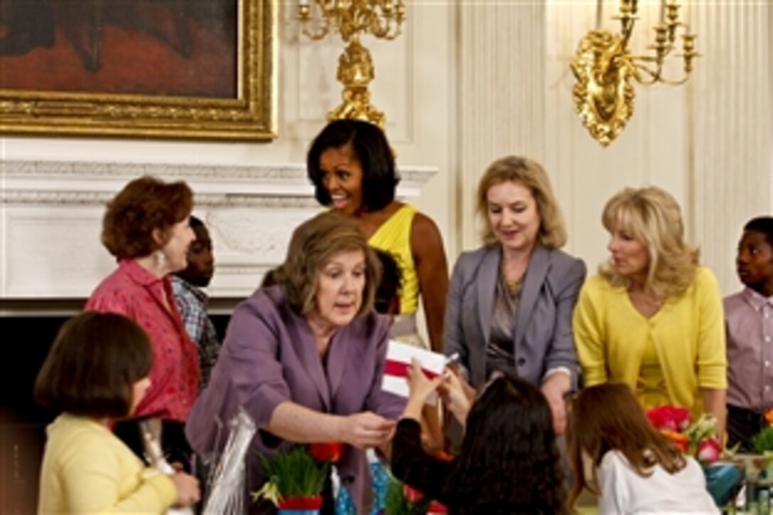 First Lady Michelle Obama and Dr. Jill Biden, wife of Vice President Joe Biden, join the children of military mothers as they make gifts at a Joining Forces Mother's Day event at the White House in Washington, D.C., May 10, 2012.