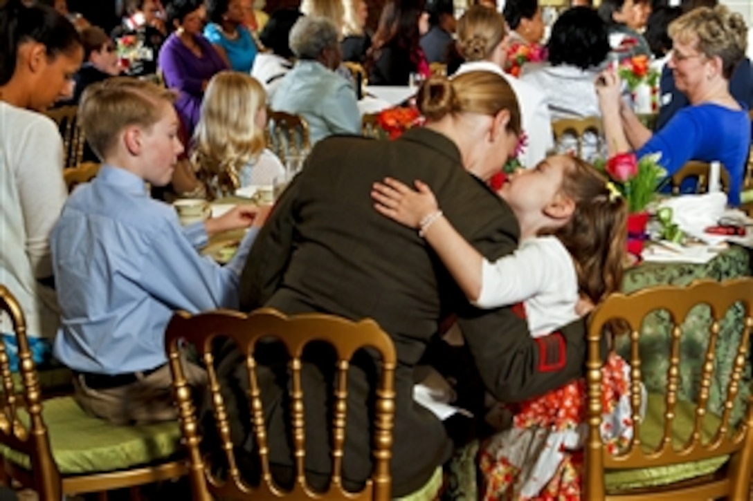 A military mom gets a hug during a Joining Forces Mother's Day event for military families hosted by First Lady Michelle Obama and Dr. Jill Biden, wife of Vice President Joe Biden, at the White House in Washington, D.C., May 10, 2012.