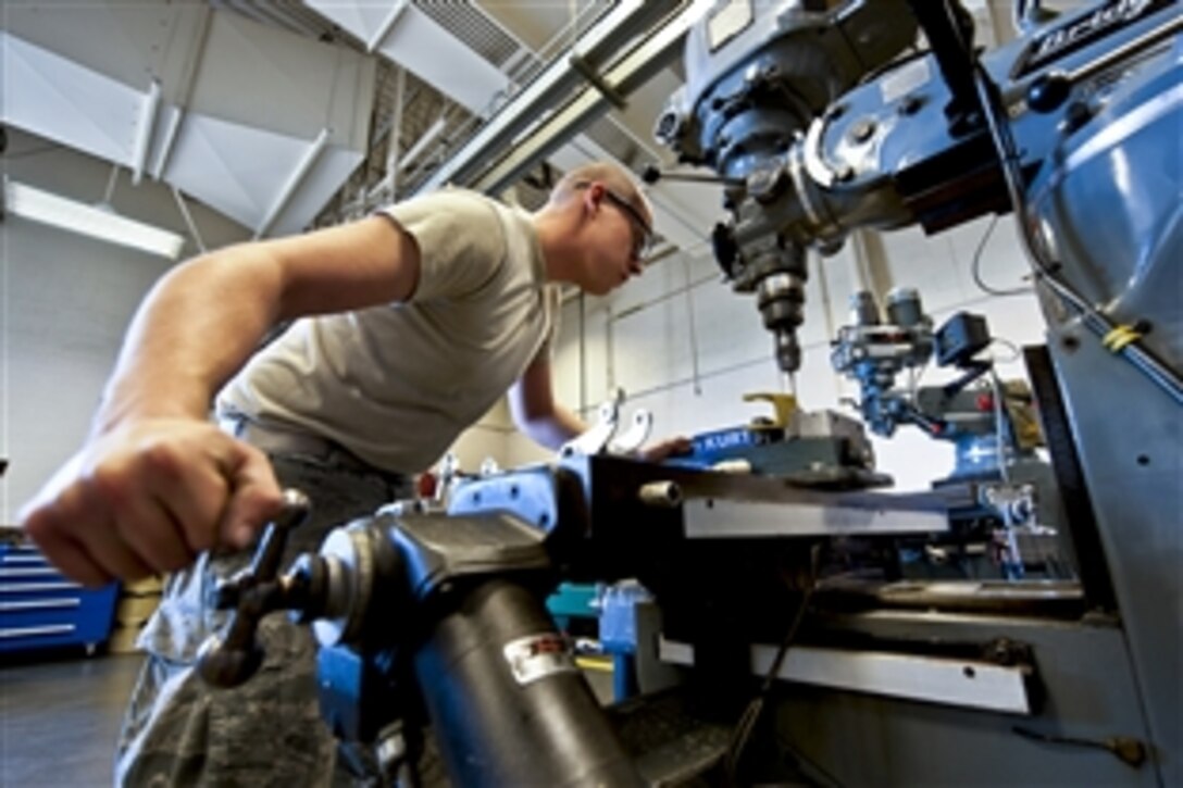 Air Force Airman 1st Class Justin Morris cuts a bushing out of an unserviceable B-1 Lancer bell crank housing in the metals technology shop on Ellsworth Air Force Base, S.D., May 2, 2012. Morris is a 28th Maintenance Squadron metals technology apprentice.