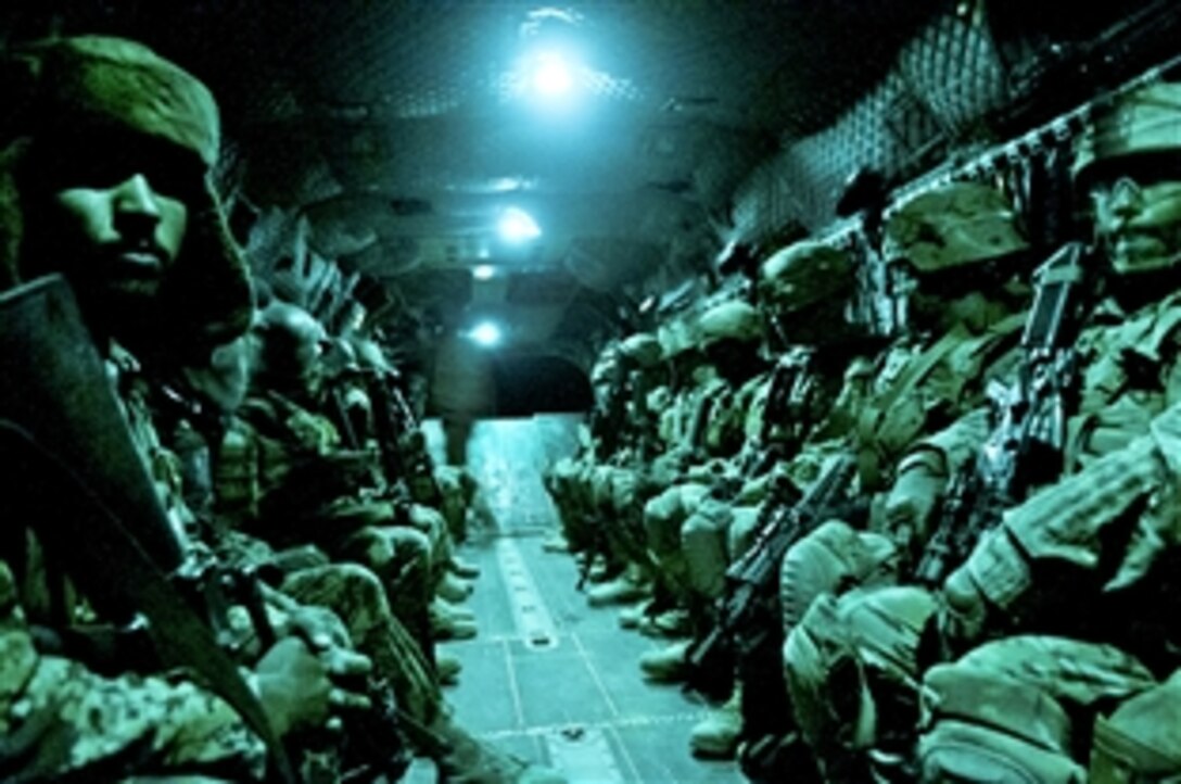 As seen through a night-vision device, U.S. Army paratroopers and Afghan soldiers travel aboard a CH-47 Chinook helicopter during an air assault mission in Afghanistan's Ghazni province, May 4, 2012.