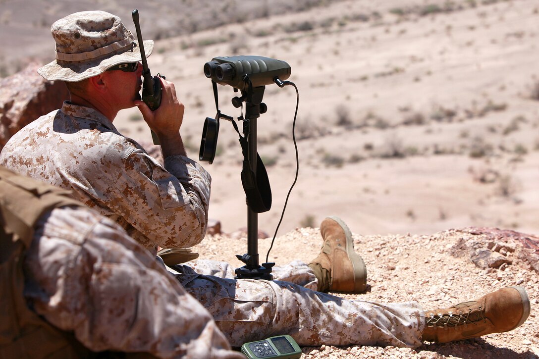 Captain Michael A. Perkins, officer-in-charge, 1st Air Naval Gunfire Liaison Company Detachment, 15th Marine Expeditionary Unit, establishes communications with aircraft, which will provide close air support, on top of an observation post, in the Chocolate Mountains, Calif., May 11. The training scenario involved his team conducting close air support operations when they requested assistance from the Tactical Recovery of Aircraft and Personnel Platoon over the radio, after they received contact from a notional local enemy attack force. The training was conducted to increase the competency of the TRAP force and as a part of the ground portion of Realistic Urban Training, which the 15th MEU is conducting in preparation for their deployment scheduled for this fall. Perkins, 36, is from Ft. Lauderdale, Fla.