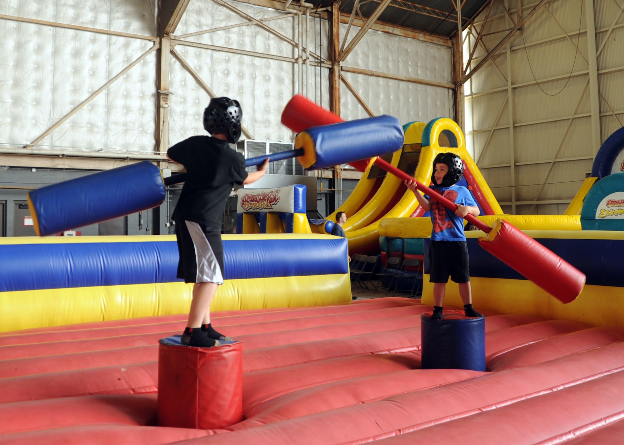 ALTUS AIR FORCE BASE, Okla. – Ty and Madden Willis battle each other in a pugil sticks match during the open house held here May 12, 2012. Altus AFB hosted an open house event which, offered food, static aircraft displays, games, and demonstrations throughout the day to show appreciation for the local community. (U.S. Air Force photo by Airman 1st Class Franklin R. Ramos / 97th Air Mobility Wing / Released)
