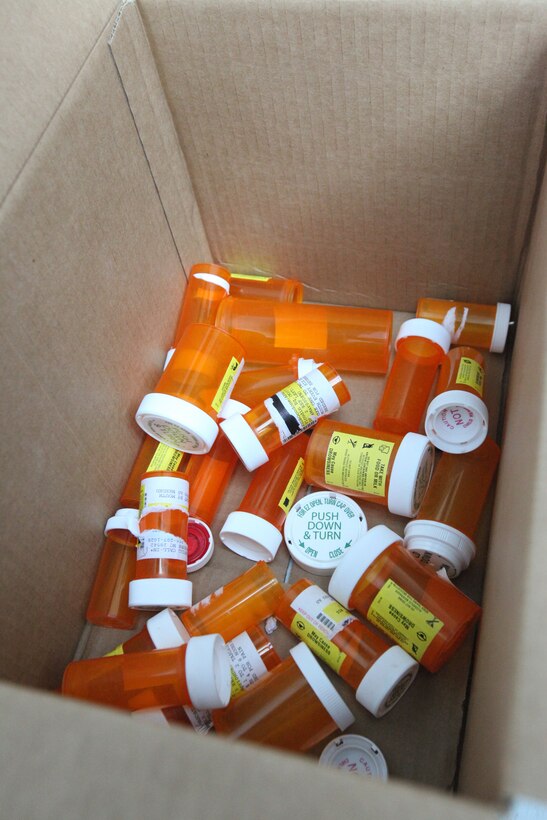 Bottles of emptied prescription drugs are tossed in a box during the Drug Take-Back event, hosted at the Marine Corps Exchange aboard Marine Corps Base Camp Lejeune, N.C., April 28.