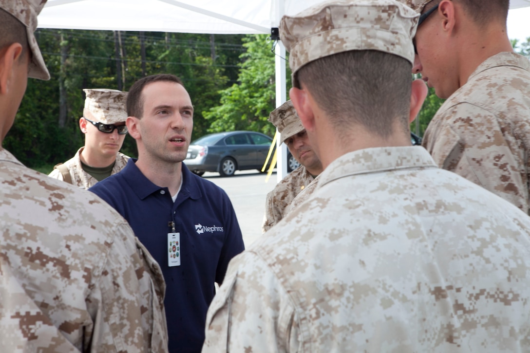 A vendor describes the product he is presenting to Marines who are in charge of judging the quality of the merchandise at the third annual Experimental Forward Operating Base aboard Marine Corps Base Camp Lejeune, May 4.