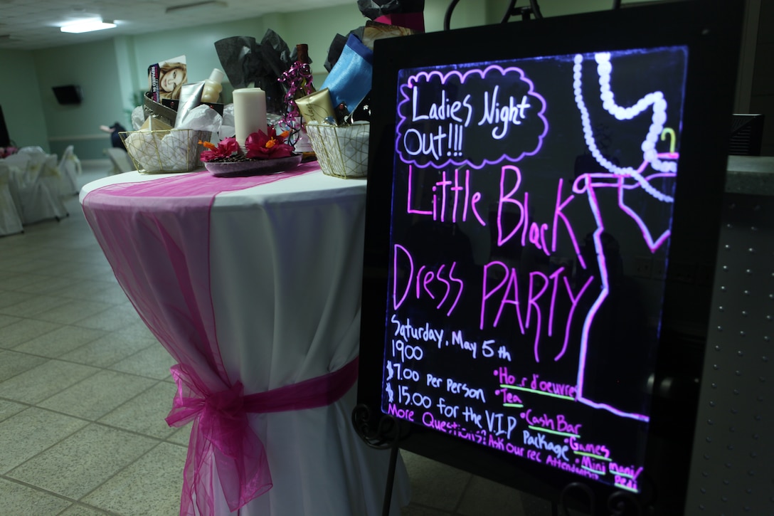 A colorful black-light sign welcomes participants to the Little Black Dress party held at the Midway Park Community Center aboard the Marine Corps Base Camp Lejeune housing area, May 5. The “female-only” party was an opportunity for women to get together for a night out and included games, dinner and many little black dresses.