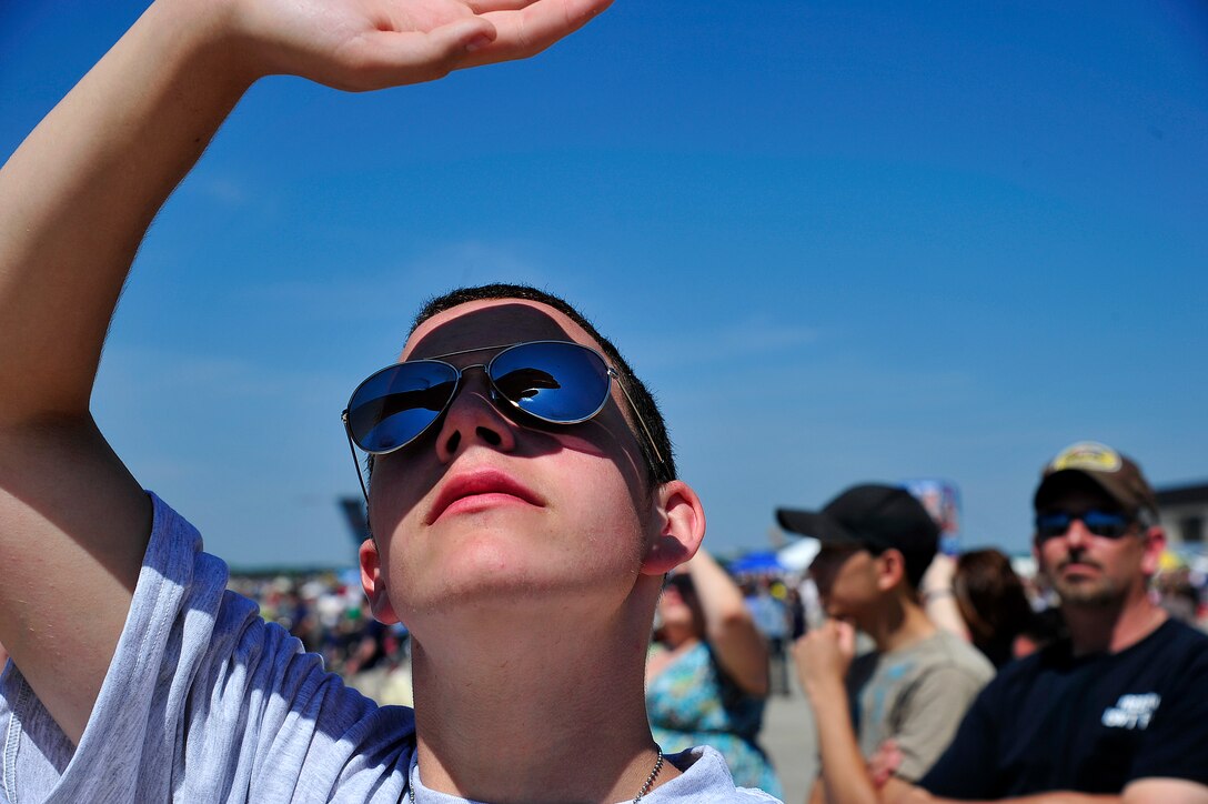 Patrick Brown, a Coatsville, Pa., native, turns his gaze upward to witness some of the aerial acrobatics at this year's open house and air show. Approximately 120,000 people crowded onto the base's airfield to witness aerial stunts and ground displays including demonstrations by the U.S. Air Force Thunderbirds F-16 Fighting Falcons and the U.S. Army Golden Knight parachute team. (U.S. Air Force photo by Tech. Sgt. Parker Gyokeres)