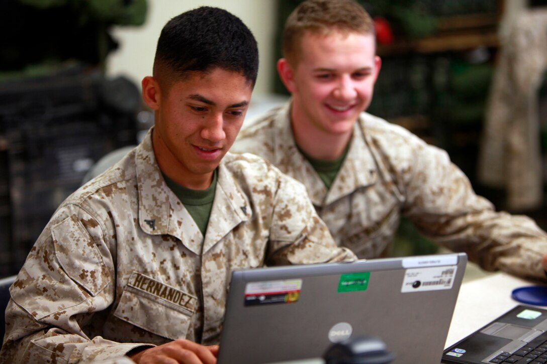 (Left to right) Lance Cpls. Richard A. Hernandez and Kyle A. Bond, both data systems technicians with the communications section, Command Element, 15th Marine Expeditionary Unit, perform network maintenance to ensure the unit has communication, at Naval Air Facility El Centro, Calif., May 13. The Marines are here as a part of the ground portion of Realistic Urban Training in preparation for the unit’s deployment scheduled for this fall. Hernandez, 20, is from Temecula, Calif., and Bond, 19, is from Placerville, Calif.