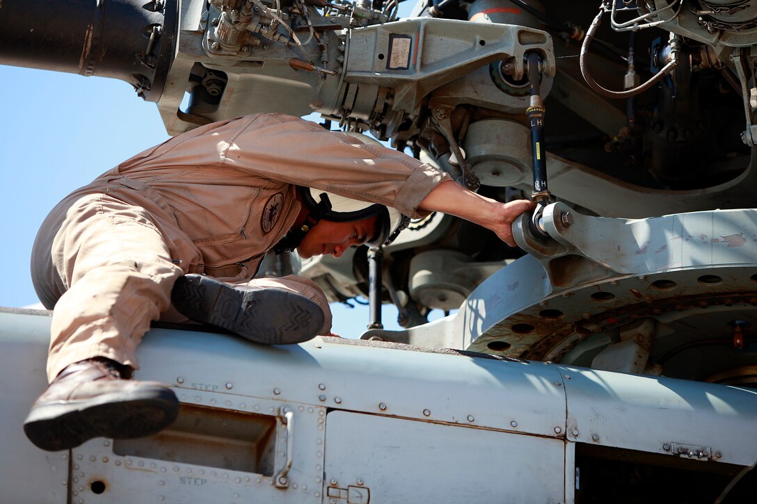 Captain Brian P. Osias, pilot, CH-53E Super Stallion, Marine Medium Helicopter Squadron 364 (reinforced), 15th Marine Expeditionary Unit, performs a pre-flight inspection on his helicopter before the day’s flight operations, at Naval Air Facility El Centro, Calif., May 13. The unit is here as a part of the ground portion of Realistic Urban Training in preparation for the unit’s deployment scheduled for this fall. Osias, 28, is from Atlanta.