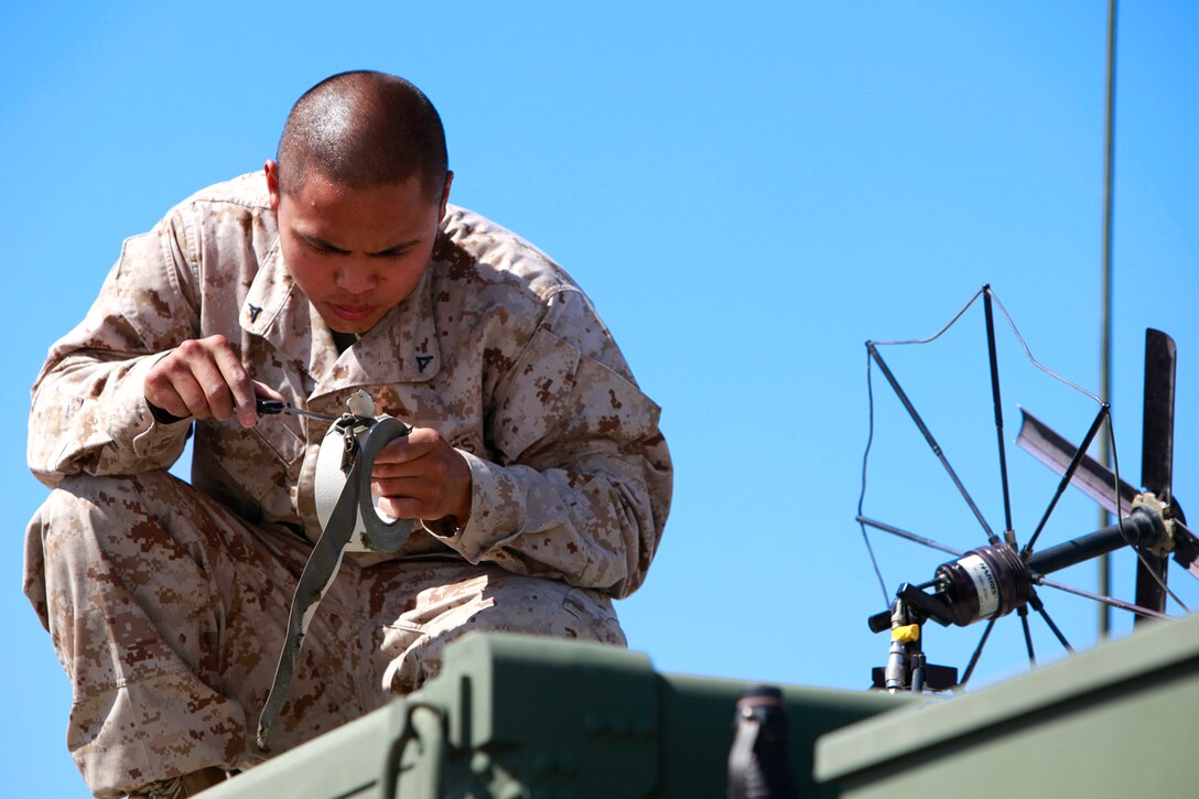 Lance Cpl. David B. Le, small amphibious craft mechanic, Reconnaissance and Surveillance Team, Battalion Landing Team 3/5, 15th Marine Expeditionary Unit, sets up a satellite antenna to communicate with teams that are in the field, at Naval Air Facility El Centro, Calif., May 13. Le is currently cross training to make him more combat effective to his team and is here as a part of the ground portion of Realistic Urban Training in preparation for the unit’s deployment scheduled for this fall. He is 20 and from Orange County, Calif.