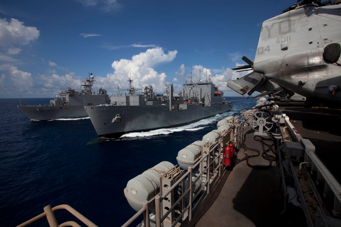 Sailors aboard USNS Washington Chambers, center, send fuel and supplies to Marines and sailors embarked aboard USS Pearl Harbor, left, and USS Makin Island, right, here May 13. The service members serve with the 11th Marine Expeditionary Unit, which embarked the ships, as well as USS New Orleans in San Diego Nov. 14, beginning a seven-month deployment to the Western Pacific, Horn of Africa and Middle East regions.