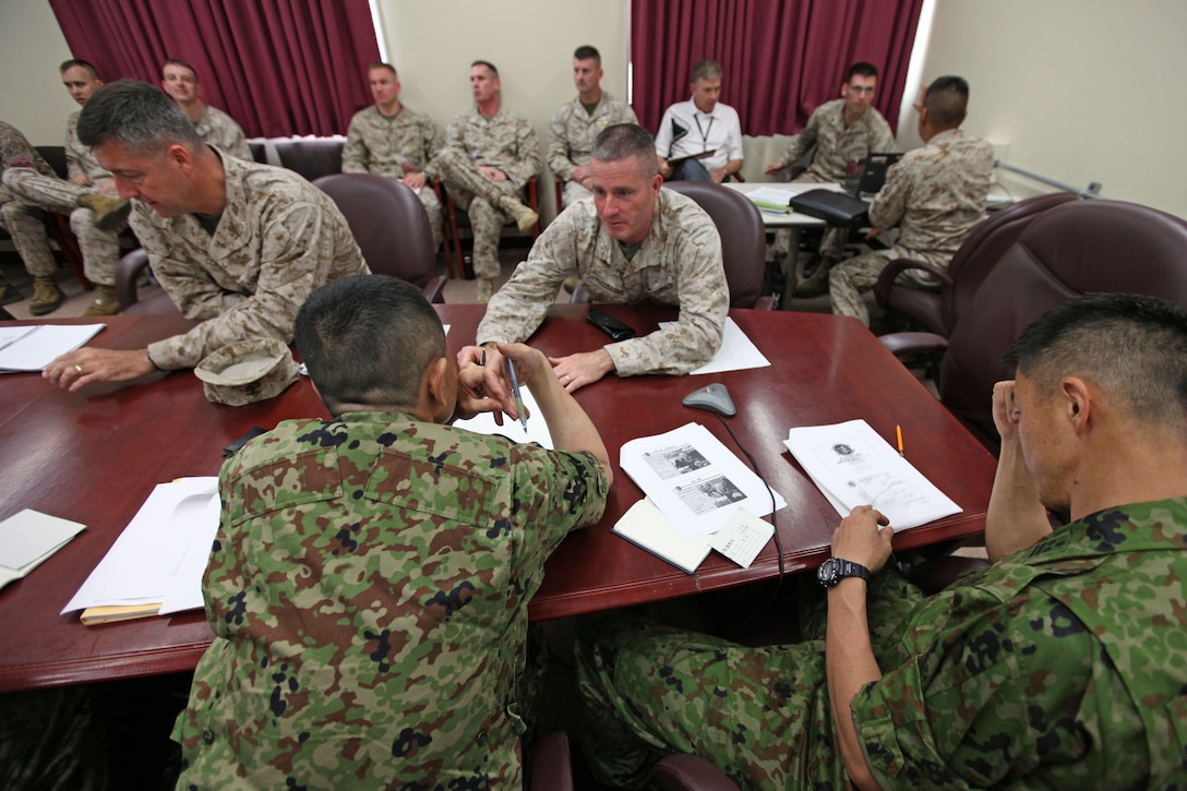 Colonel Christopher P. Coke (Left), assistant chief of staff for operations, III Marine Expeditionary Force, and Col. Andrew R. MacMannis, commanding officer for the 31st Marine Expeditionary Unit, speak with members of the Japanese Self Defense Forces during a meeting in the 31st MEU headquarters, May 14. The JSDF requested a meeting with the MEU, to gain a better familiarity with the unit's expeditionary and amphibious capabilities. The 31st MEU is the only continuously forward deployed MEU, and the United States' force in readiness for the Asia Pacific region.