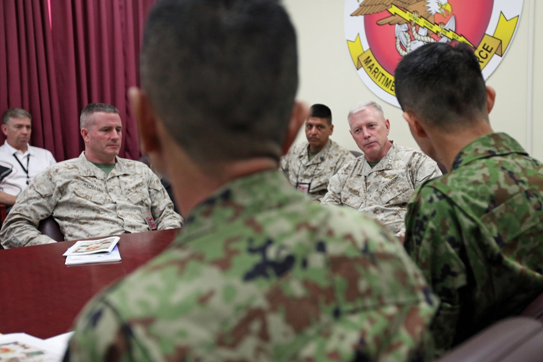 Lieutenant Gen. Kenneth J. Glueck Jr. (Right), commanding general of III Marine Expeditionary Force, and Col. Andrew R. MacMannis, commanding officer of the 31st Marine Expeditionary Unit, speak with members of the Japanese Self Defense Forces inside the MEU headquarters, May 14. The JSDF requested a meeting with MEU staff to learn more about the unit's capabilities in expeditionary and amphibious operations. The 31st MEU is the only continuously forward deployed MEU and the United States' force in readiness for the Asia Pacific region.