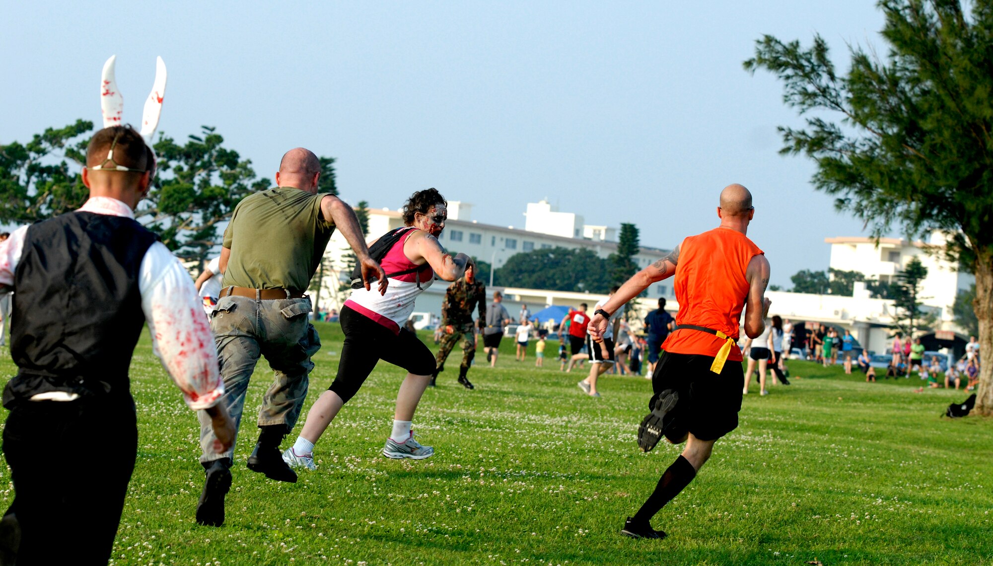 A participant "runs for his life" to avoid having his flags captured by "zombies" during the That Others May Live Foundation 5K charity event at Kadena Air Base, Japan, May 11, 2012. Volunteers dressed as zombies to chase runners around various obstacle points along the course. The event raised more than $12,000 for the non-profit charity which provides critical support, scholarships and immediate tragedy assistance for the families of United States Air Force Rescue Heroes who are killed or severely wounded in operational or training missions. (U.S. Air Force photo/Airman 1st Class Malia Jenkins)