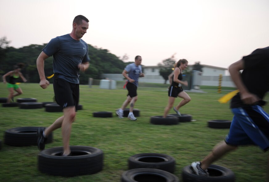 Participants run through a tire obstacle, one of the many they had to conquer during a zombie themed 5K for That Others May Live Foundation on Kadena Air Base, Japan, May 11, 2012. After the participants completed the obstacles, they found groups of undead waiting to capture their flags. The event raised over $12,000 for the non-profit charity which provides critical support, scholarships and immediate tragedy assistance for the families of United States Air Force Rescue Heroes who are killed or severely wounded in operational or training missions. (U.S. Air Force photo/Airman 1st Class Justin Veazie)