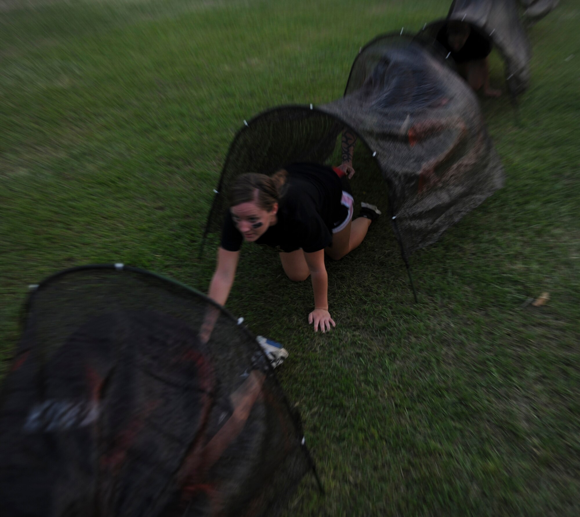 U.S. Air Force Airman 1st Class Tiffany Fogel, 82nd Reconnaissance Squadron knowledge operator, crawls through tunnels during a zombie themed 5K for That Others May Live Foundation on Kadena Air Base, Japan, May 11, 2012. Runners had to complete various obstacles while avoiding undead who were trying to capture their flags. The obstacle course had more than 700 participants and raised over $12,000 for the foundation. (U.S. Air Force photo/Airman 1st Class Justin Veazie)