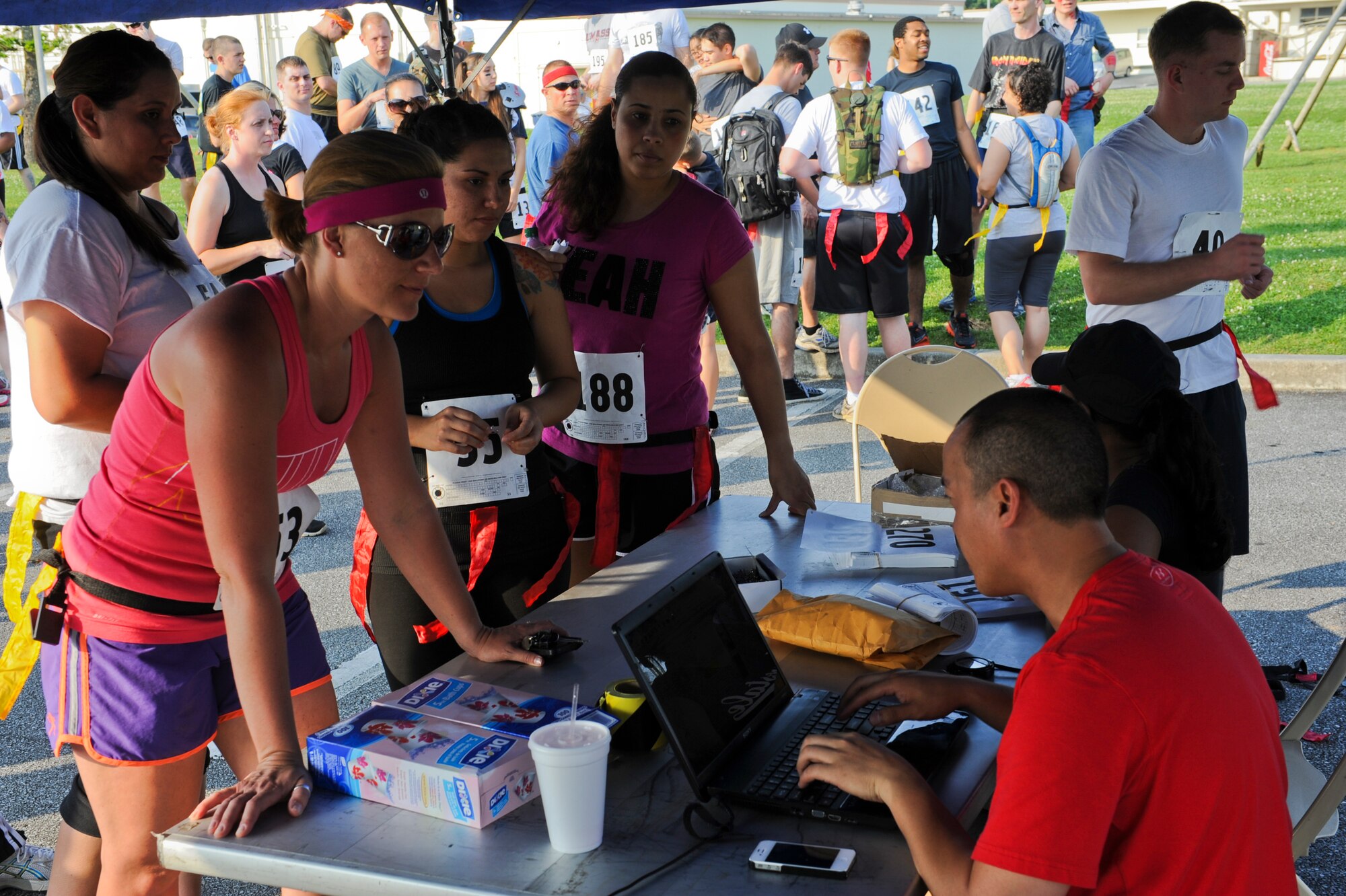 Participants register to run for their lives to raise funds for 'That Others May Live Foundation' on Kadena Air Base, Japan, May 11, 2012. The 5K event featured actors, dressed as zombies who's goal it was to snag flags off of the contestants as they made their way through obstacles and terrain. The event raised over $12,000 for the non-profit charity which provides critical support, scholarships and immediate tragedy assistance for the families of United States Air Force Rescue Heroes who are killed or severely wounded in operational or training missions. (U.S. Air Force photo/Airman 1st Class Justin Veazie)