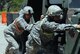 Soldiers participate in a “Dead Battery Push.” Each team had to push a Humvee  through an obstacle course, check the oil, and count the number of bolts on the undercarriage. (U.S. Army photo by Sgt. Tracy Ellingsen)