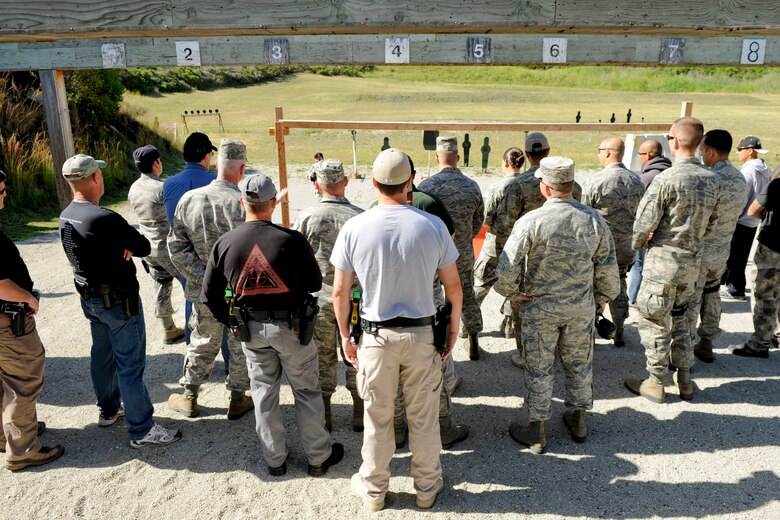VANDENBERG AIR FORCE BASE, Calif.-- Participants observe the course of a pistol competition at the combat arms training range here Monday, May 14, 2012. The competition was held in conjunction with National Police Week, an annual celebration that recognizes the service and sacrifice of U.S. law enforcement personnel. (U.S. Air Force photo/Staff Sgt. Levi Riendeau)