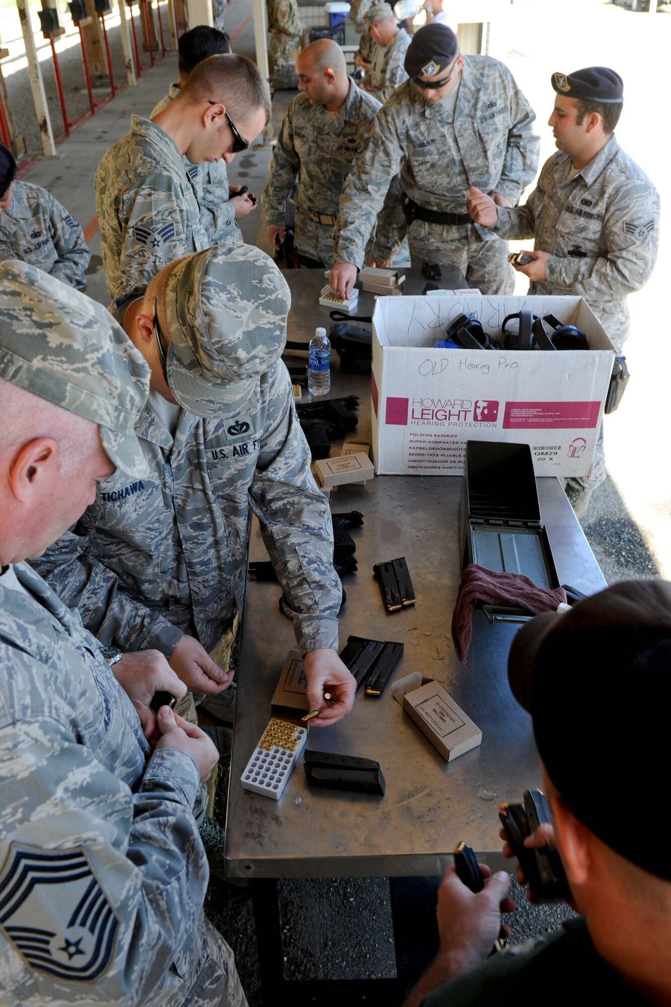 VANDENBERG AIR FORCE BASE, Calif.-- Participants load magazines before a pistol competition at the combat arms training range here Monday, May 14, 2012. The competition was held in conjunction with National Police Week, an annual celebration that recognizes the service and sacrifice of U.S. law enforcement personnel. (U.S. Air Force photo/Staff Sgt. Levi Riendeau)