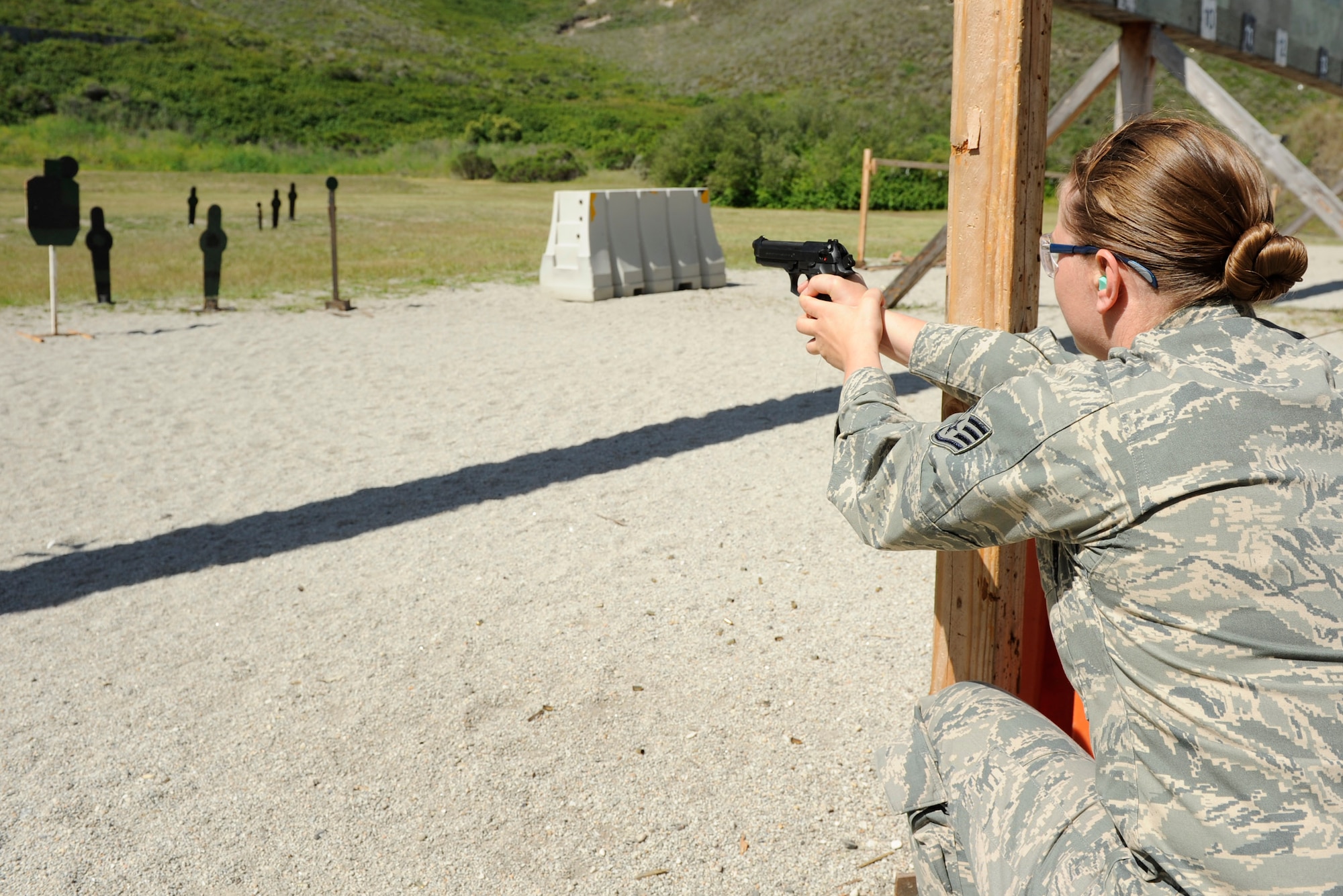 VANDENBERG AIR FORCE BASE, Calif.-- Staff Sgt. Jennifer Cunningham, an Airman Leadership School instructor, shoots at targets during a pistol competition at the combat arms training range here Monday, May 14, 2012. The competition was held in conjunction with National Police Week, an annual celebration that recognizes the service and sacrifice of U.S. law enforcement personnel. (U.S. Air Force photo/Staff Sgt. Levi Riendeau)