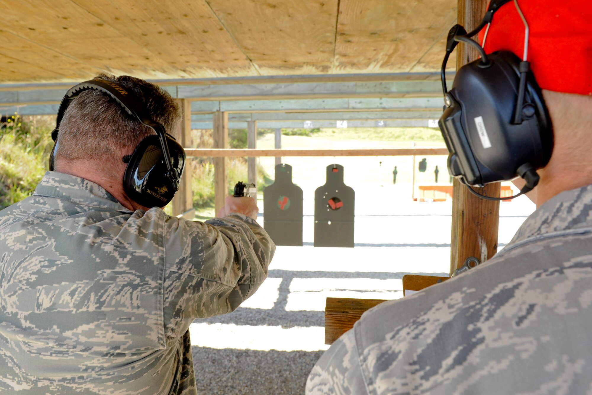 VANDENBERG AIR FORCE BASE, Calif.-- Col. Kelly Kirts, the 30th Mission Support Group commander, shoots at targets during a pistol competition at the combat arms training range here Monday, May 14, 2012. The competition was held in conjunction with National Police Week, an annual celebration that recognizes the service and sacrifice of U.S. law enforcement personnel. (U.S. Air Force photo/Staff Sgt. Levi Riendeau)