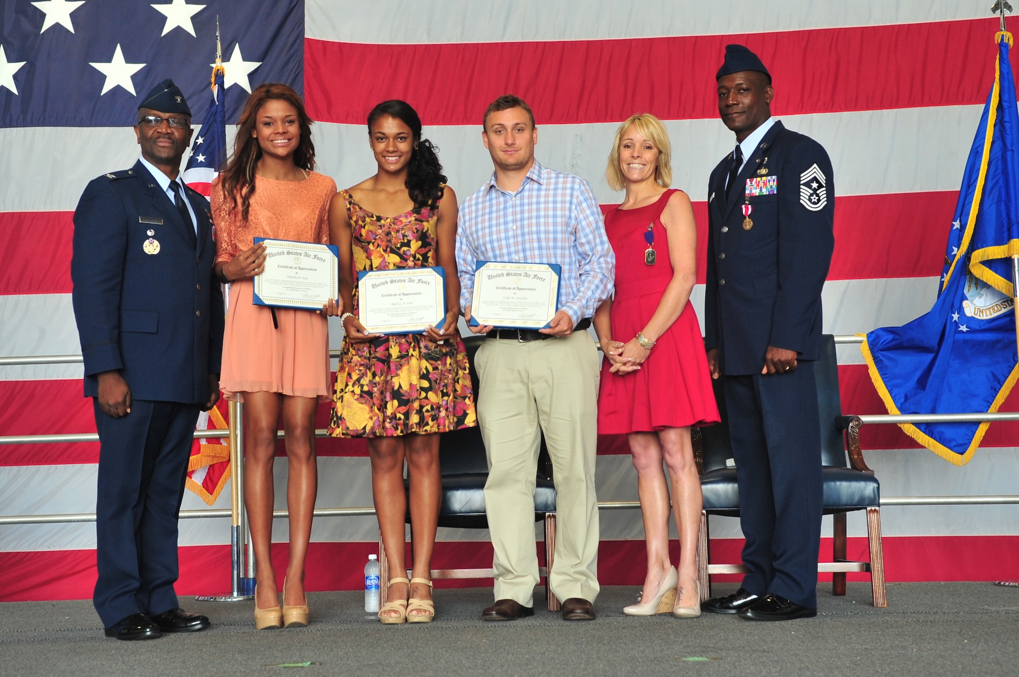 U.S. Air Force Chief Master Sgt. Lefford Fate, 20th Fighter Wing command chief, poses for a photo with his family as they accept their certificates of appreciation for their participation in his dedicated service, Shaw Air Force Base, S.C. May 1, 2012. Fate retired after 30 years of service. (U.S. Air Force photo by Airman 1st Class Ashley L. Gardner/ Released)
