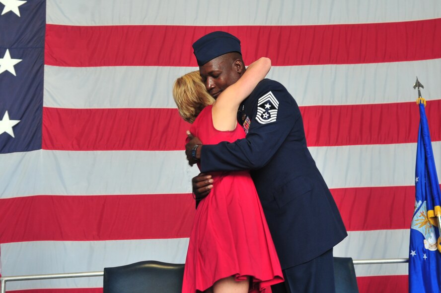 U.S. Air Force Chief Master Sgt. Lefford Fate 20th Fighter Wing command chief, hugs his wife Jody Fate during his retirement ceremony, Shaw Air Force Base, S.C., May 1, 2012. Fate and Jody have been married for 18 years. Fate retired after 30 years of service. (U.S. Air Force photo by Airman 1st Class Ashley L. Gardner/ Released)