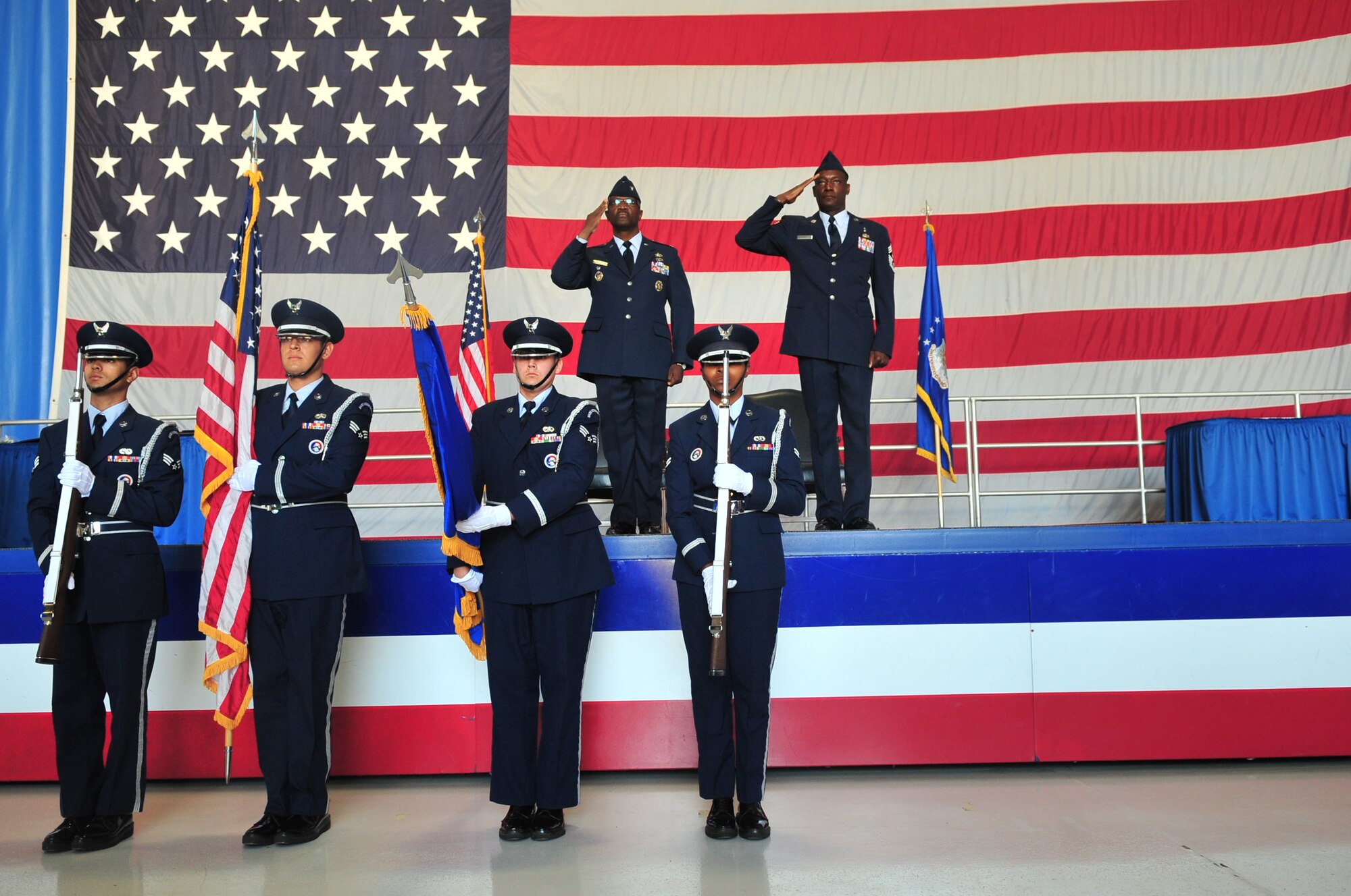 U.S. Air Force Col. Freddie J. Sherman, Department of State for Afghanistan transition logistics directorate, and Chief Master Sgt. Lefford Fate, 20th Fighter Wing command chief, show proper customs and courtesies by saluting during the national anthem, Shaw Air Force Base, S.C. May 1, 2012. Fate retired at Shaw after serving 30 years in the Air Force. (U.S. Air Force photo by Airman 1st Class Ashley L. Gardner/ Released)