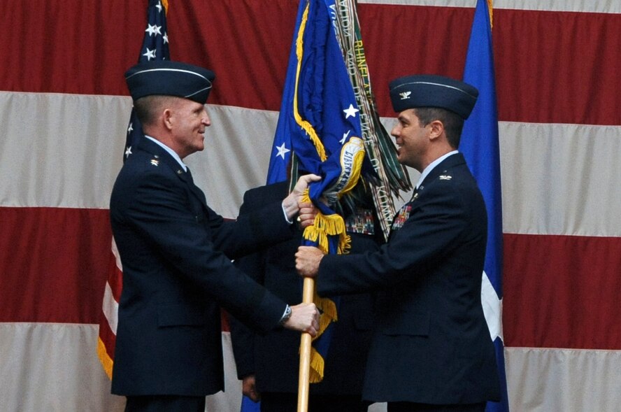 Maj. Gen. Stephen Wilson, 8th Air Force commander, passes the 2nd Bomb Wing guidon to Col. Andrew Gebara, incoming commander, during the 2 BW change-of-command ceremony on Barksdale Air Force Base, La., May 14. The change-of-command ceremony is a military tradition that gives service members the opportunity to witness their new leader's assumption of command. Gebara previously served as the vice commander of the 509th Bomb Wing at Whiteman AFB, Mo.(U.S. Air Force photo/Airman 1st Class Micaiah Anthony)(RELEASED)