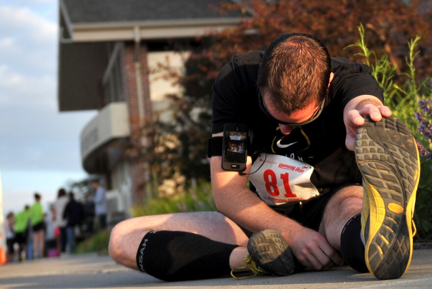 Chris North of Bellevue, Neb., stretches before the Bellevue-Offutt Runway Run in Bellevue, Neb., May 13. The race, held annually on Mother's Day, has become a local tradition at Bellevue and Offutt Air Force Base. (U.S. Air Force photo by Jeff W. Gates/Released)