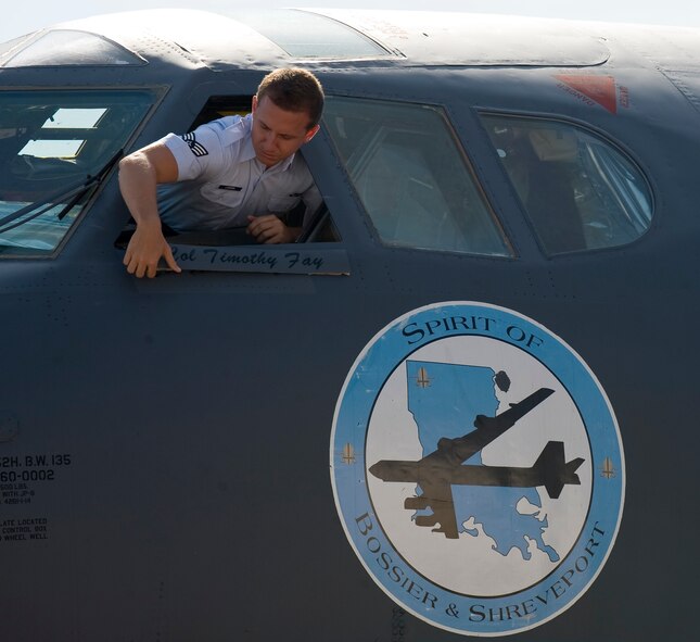 Senior Airman James Lawson, 2nd Aircraft Maintenance Squadron crew chief, removes Col. Tim Fay's name from the flagship B-52 of the 2nd Bomb Wing to reveal new wing commander Col. Andrew Gebara's name during the 2 BW change of command on Barksdale Air Force Base, La., May 14. Fay commanded the 2 BW from July 19, 2010 until May 14, 2012. (U.S. Air Force photo/Staff Sgt. Chad Warren)(RELEASED)