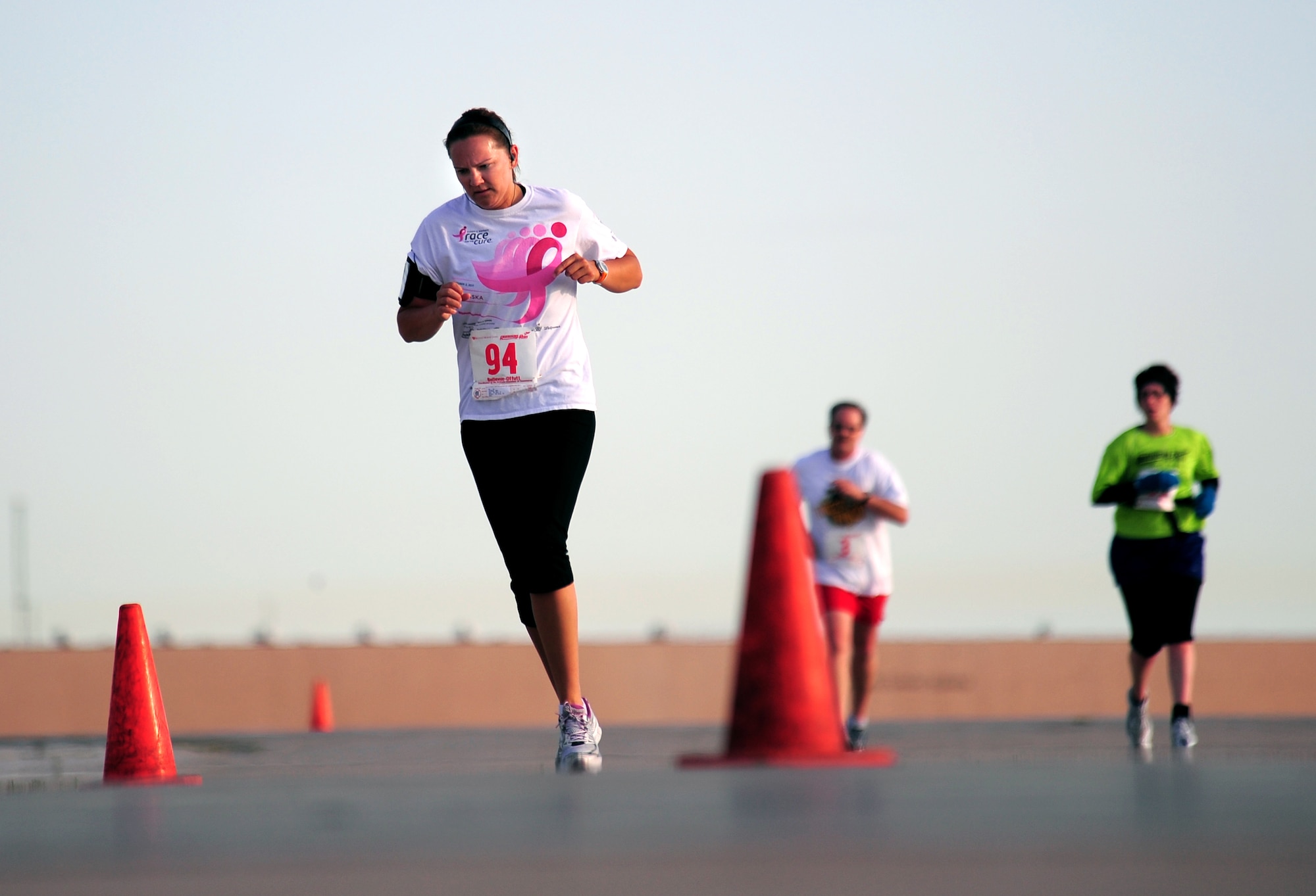Amy Schram of Bellevue makes her way down the flightline while participating in the annual Bellevue-Offutt Runway Run at Offutt Air Force Base, Neb., May 13. This is the fifth annual run which starts at the Lied Center in Bellevue and takes participates through base before returning to the Lied Cent. (U.S. Air Force Photo by Josh Plueger)